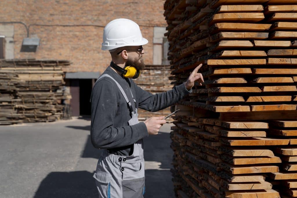 man working mdf boards warehouse 1 Looking for a Wood Drying Kiln Near You? Here’s What to Consider Wood Drying Kiln